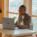 Women working on a laptop on her dining room table